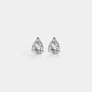 Pair of pear-shaped diamond earrings on a light gray background