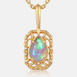 Gold pendant with a teardrop-shaped opal gemstone on a white background