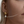 Close-up of a person wearing gold hoop earrings with a pearl accent.