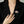 Person wearing a decorative brooch on a black blazer