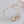 Delicate gold and pearl headband on a light gray background
