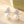 Pearl earrings with floral designs on a soft background