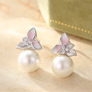 Pearl earrings with floral designs on a soft background