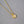 A collection of three pearl necklace chains with gold-plated rose flower pendants, displayed on a grey background.