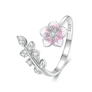 Silver ring with pink flower design on a white background