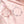 Two floral anklets on a soft pink fabric background with cherry blossom petals.