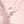 Two dainty necklaces with pink cherry blossom pendant designs, one with a gold plating and the other with a silver plating, displayed on a pink background.