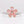Ring with pink gemstone flower design on a light gray background