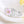 Silver ring with pink and white floral designs on a light background