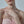 Woman wearing a pink strapless dress with a blurred background