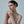 Woman wearing a strapless pink dress against a plain background
