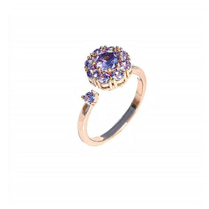 Two rings, one with a clear and one with pink cubic zirconia stones, both with a floral design, displayed against a white background.