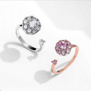 Two diamond rings, one silver and one rose gold, on a white background