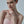 Woman wearing a strapless pink dress with a plain background