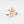 Gold ring with pink gemstones on a light gray background