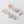 Set of pearl earrings on a light gray background