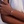 Close-up of a hand wearing a gold bracelet with a cross charm.