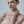 Woman wearing a pink strapless top against a light background