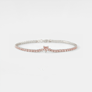 Silver bracelet with pink heart-shaped gemstone on a white background