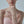Woman wearing a pink strapless dress with a blurred background