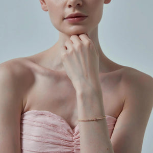 Woman wearing a pink strapless dress with a blurred background