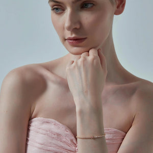 Woman wearing a strapless pink dress with a plain background
