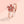 Rose gold ring with a red floral design on a pink background