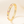 Gold ring with colorful gemstones on a beige background
