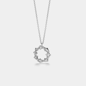 Silver geometric pendant necklace on a light gray background