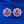 Pair of pink gemstone earrings with silver settings on a blue background