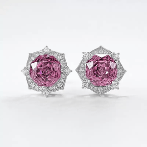 Pair of pink gemstone earrings with diamond accents on a white background