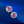 Pair of pink gemstone earrings on a blue fabric background