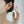 Close-up of a person wearing a paw print earring with a blurred background