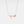A rose gold-plated necklace with a solid 925 sterling silver chain and a charm featuring a tulip flower with rose quartz petals and cubic zirconia accents.