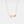 A gold-plated necklace with a solid 925 sterling silver chain and a charm featuring a tulip flower with rose quartz petals and cubic zirconia accents.