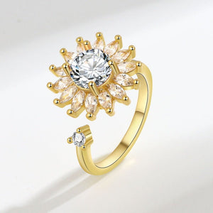 Gold ring with a diamond on a light gray background
