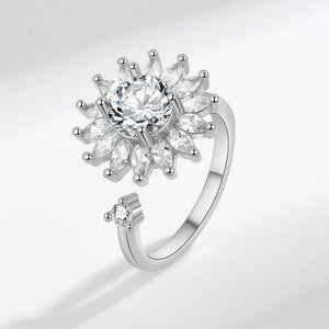 Silver ring with a diamond on a light gray background
