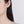 Earring worn by a model on a plain background