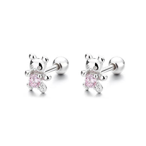 Pair of silver teddy bear earrings with pink gemstones on a white background