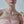 Woman wearing a delicate necklace with a minimal background