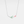 A silver necklace with a charm depicting a horizontal tulip flower, featuring green leaves and a pink petal.