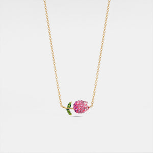 Gold necklace with a pink flower pendant on a white background