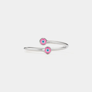 Silver ring with pink evil eye charms on a light gray background