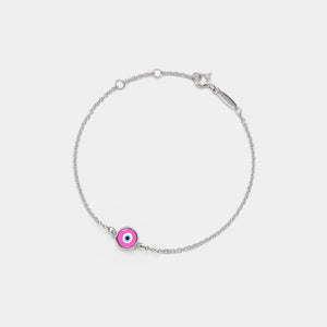Silver bracelet with a pink evil eye charm on a light gray background