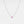 Necklace with a small round pendant on a light gray background