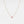 Necklace with a small round pendant on a light gray background