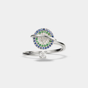 Silver saturn spinner ring with gemstones on a white background