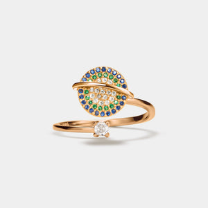 Rose gold saturn spinner ring with gemstones on a white background