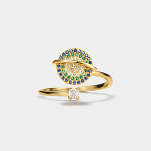 Gold saturn spinner ring with gemstones on a white background