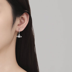 Earring worn by a person with a neutral background